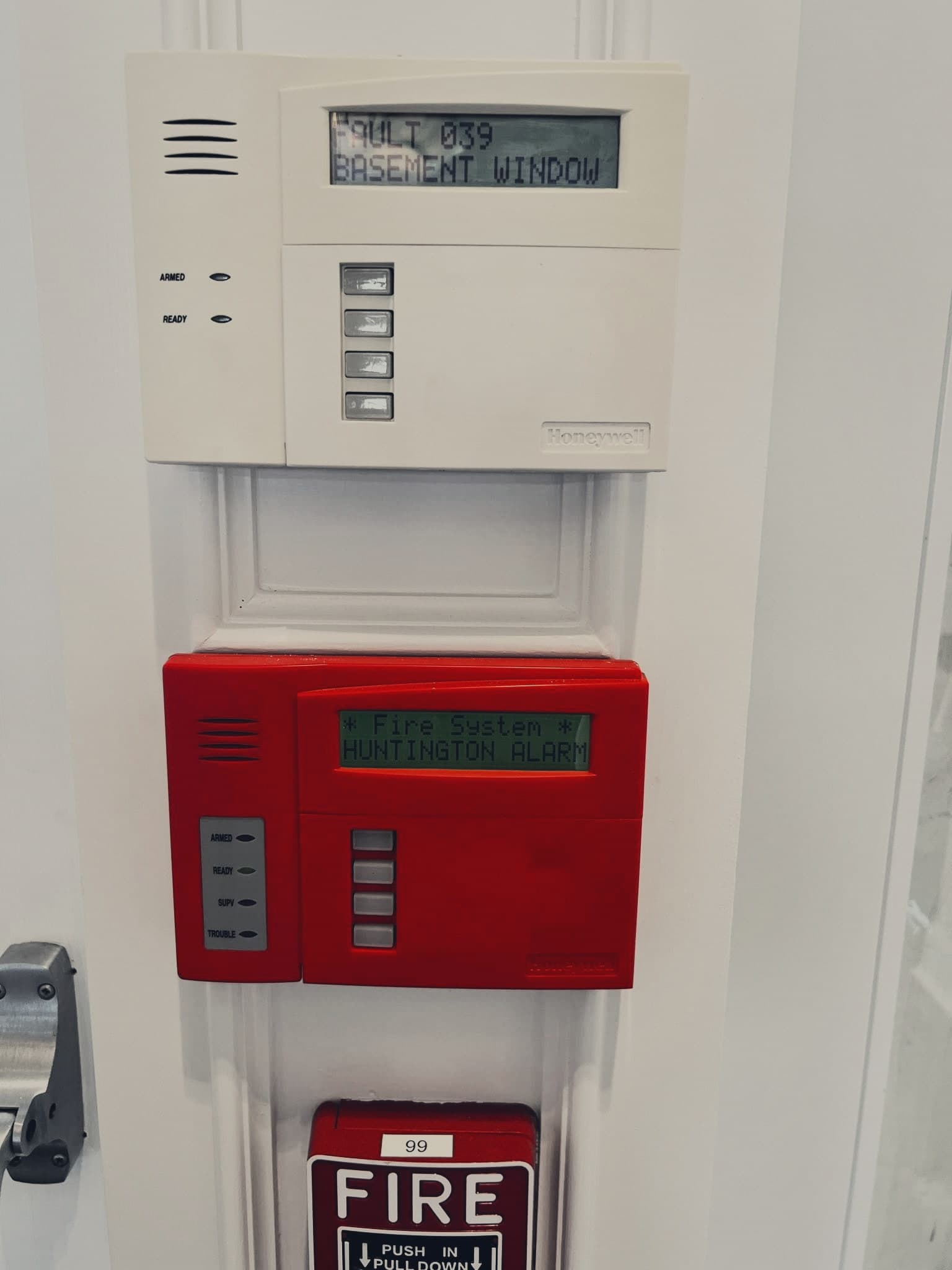 A fire alarm control panel and pull station.